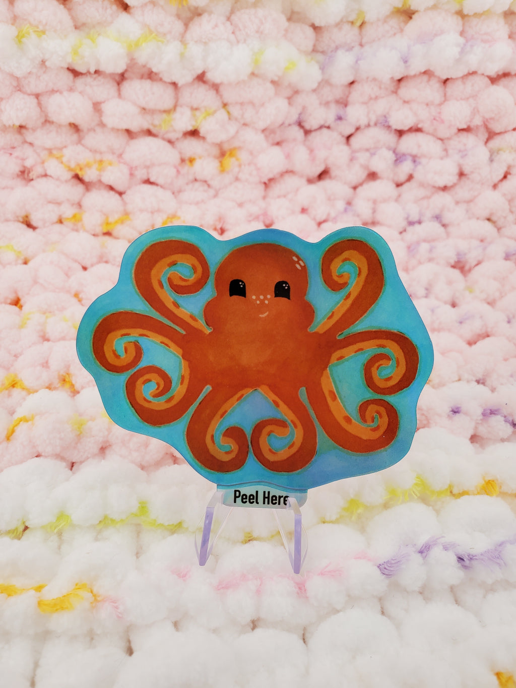 2 and a half-inch holographic vinyl sticker of an orange octopus. Octopus with tentacles in the shape of love hearts.